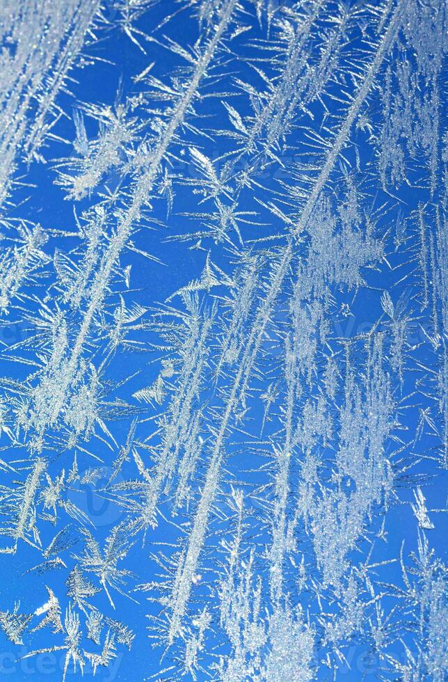 Ice on a window blue white vertical photo