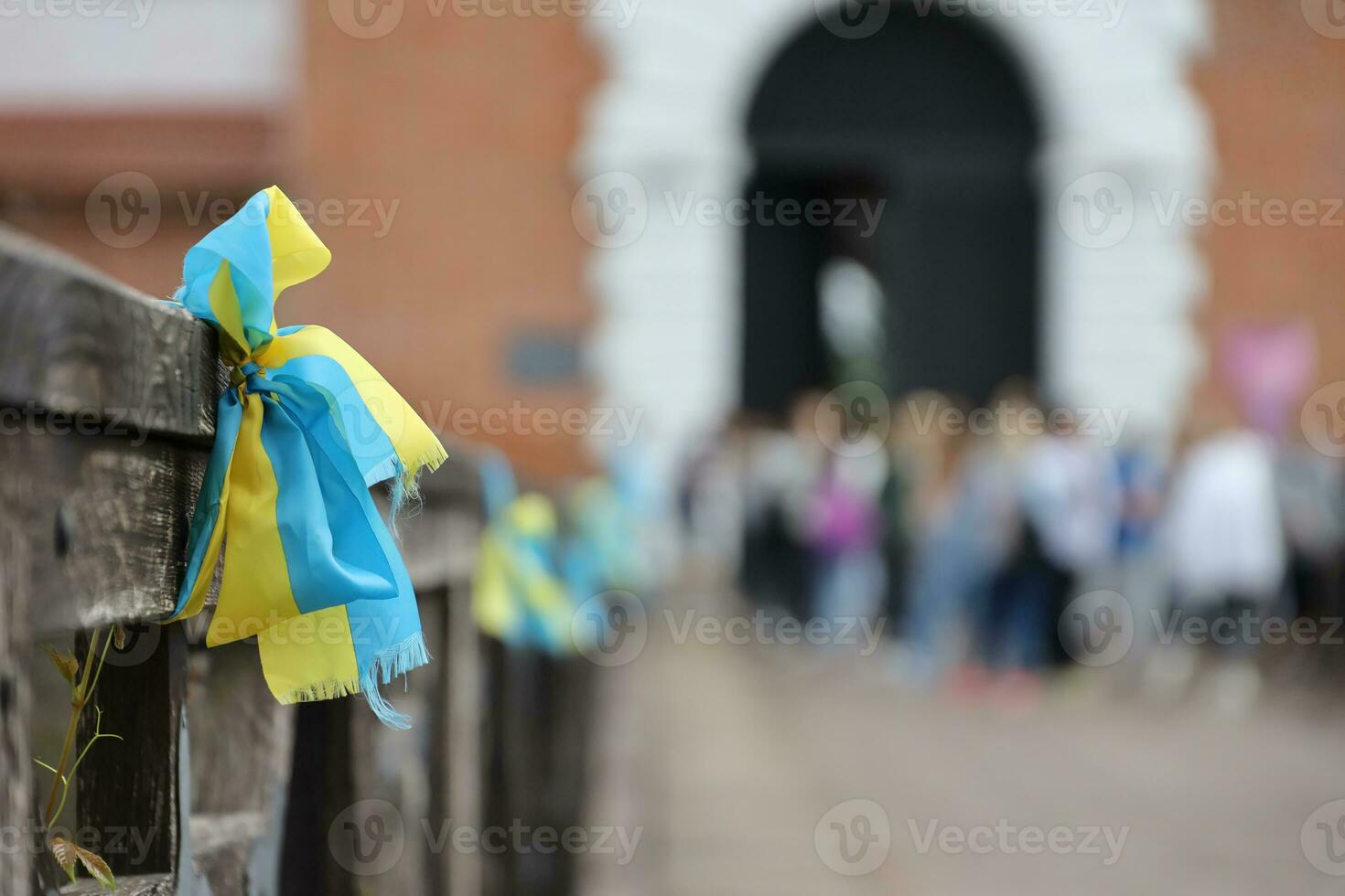Ribbons in the colors of the national flag of Ukraine are tied to the handrail photo