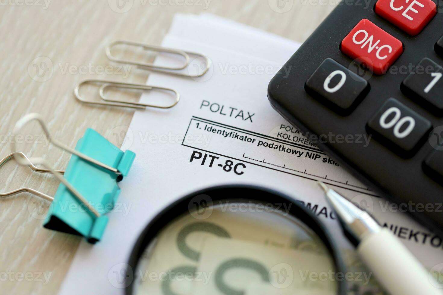 Information about some income from monetary capital, PIT-8C form on accountant table with pen and polish zloty money bills photo