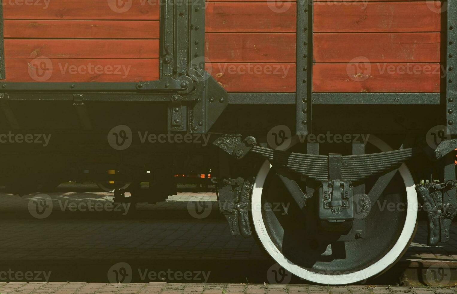 The side of the old brown wooden freight car with the wheel of the times of the Soviet Union photo