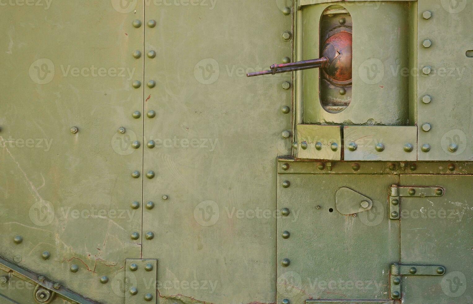 The texture of the wall of the tank, made of metal and reinforced with a multitude of bolts and rivets. Images of the covering of a combat vehicle from the Second World War with a guided machine gun photo