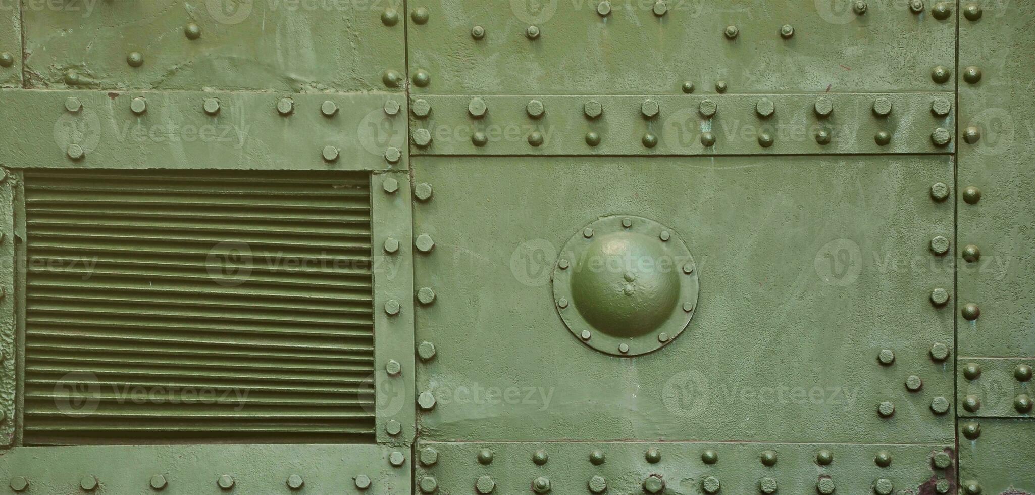 The texture of the wall of the tank, made of metal and reinforced with a multitude of bolts and rivets. Images of the covering of a combat vehicle from the Second World War photo