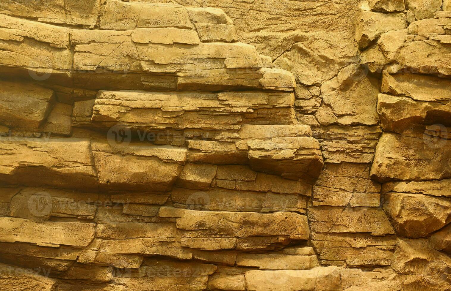 Light coarse natural rock stone background. Mining cliff rough front surface. Big limestone stack backdrop. Heavy grunge damaged granite block texture photo