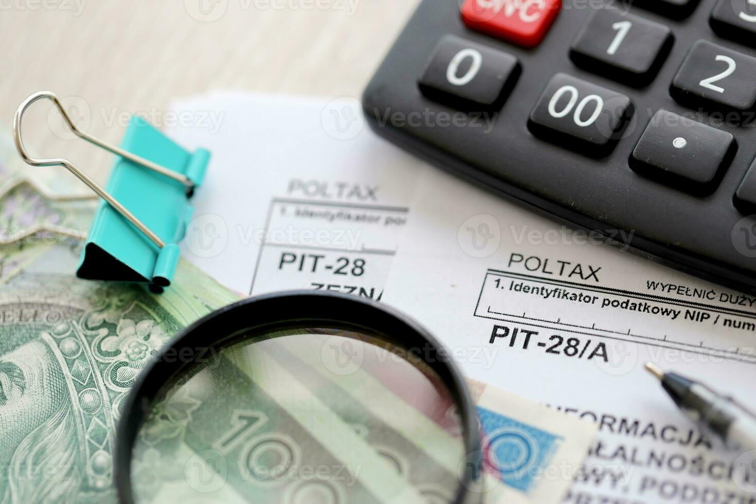 Information of income of inherited enterprise PIT28 and PIT-28A tax forms on accountant table with pen and polish zloty money bills photo