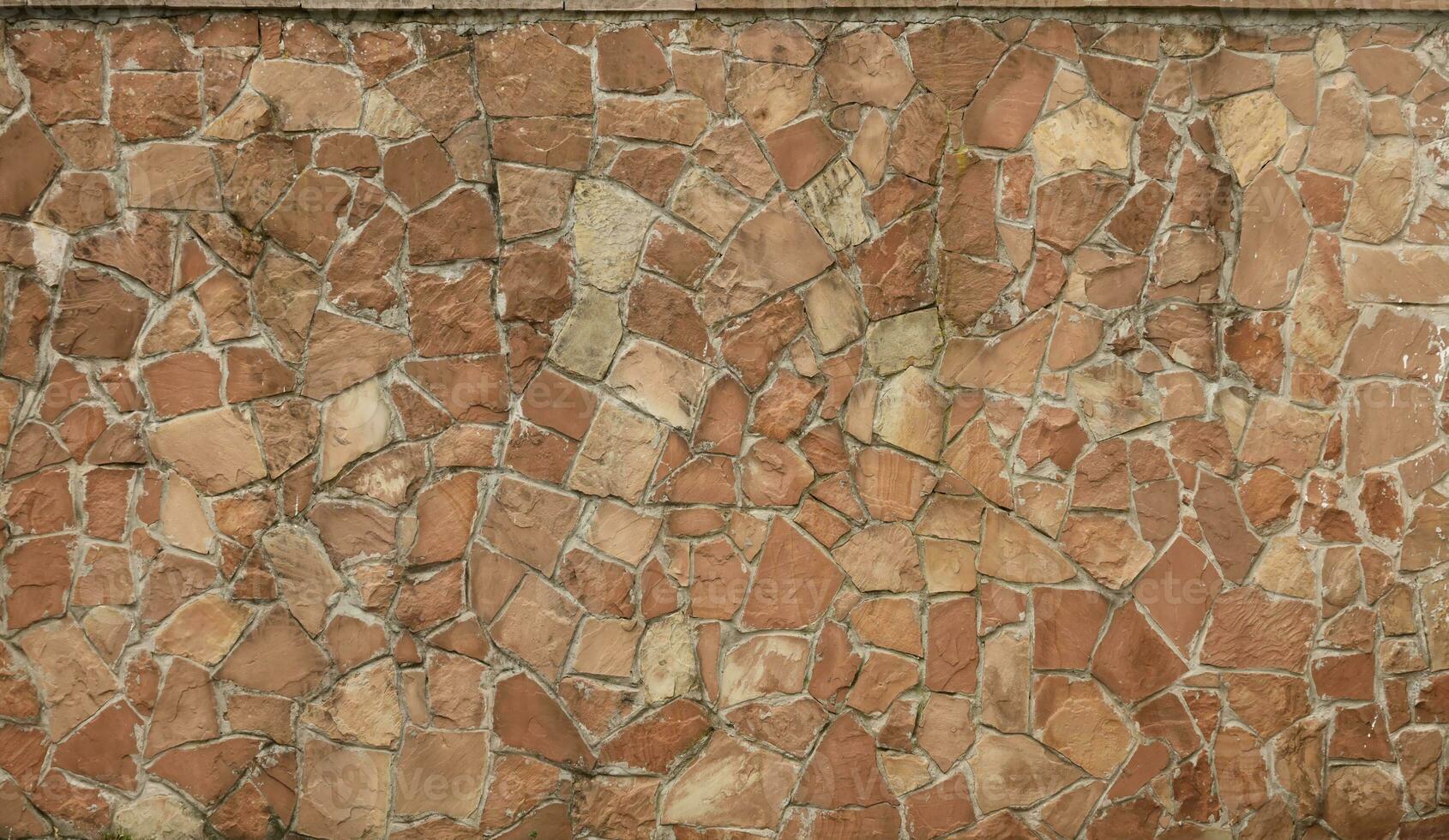 Very old brick stone wall of castle or fortress of 18th century. Full frame wall with obsolete dirty and cracked bricks photo