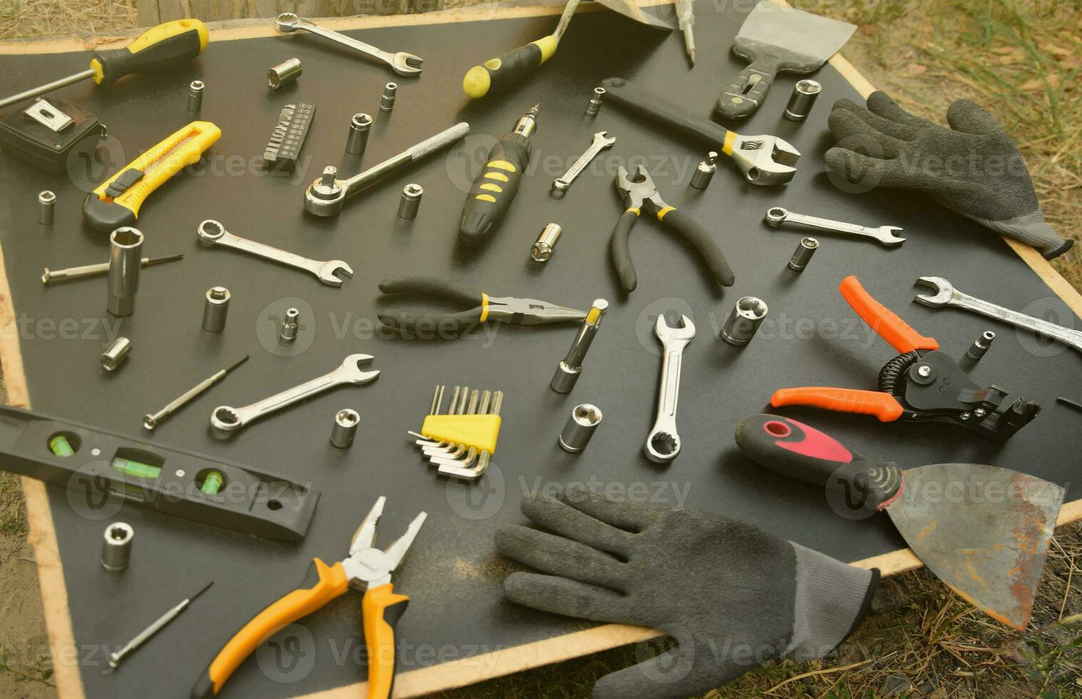 Handyman tool kit on black wooden table. Many wrenches and screwdrivers, pilers and other tools for any types of repair or construction works. Repairman tools photo