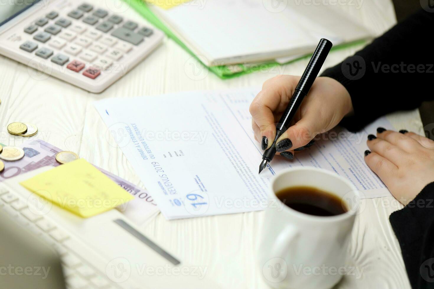 Accountant fill french tax form 2042 NR departure abroad or return to France in end of tax period. Taxation and paperwork routine photo