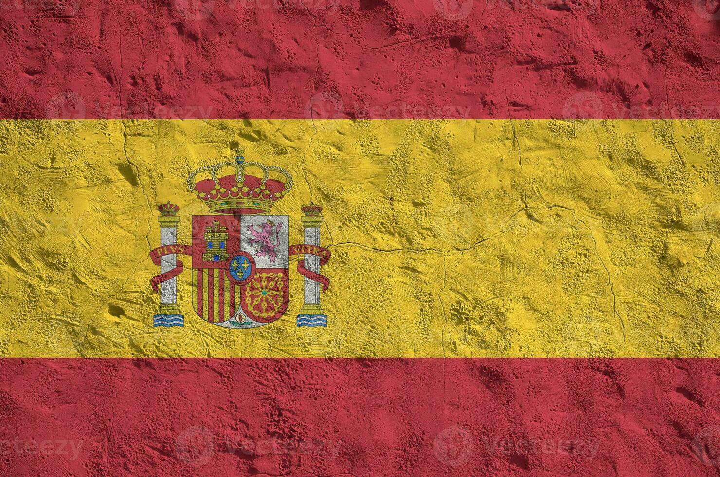 Spain flag depicted in bright paint colors on old relief plastering wall. Textured banner on rough background photo