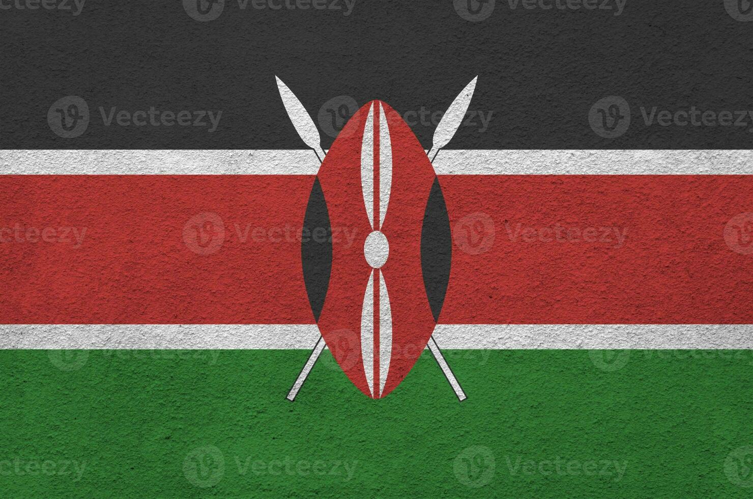 Kenya flag depicted in bright paint colors on old relief plastering wall. Textured banner on rough background photo