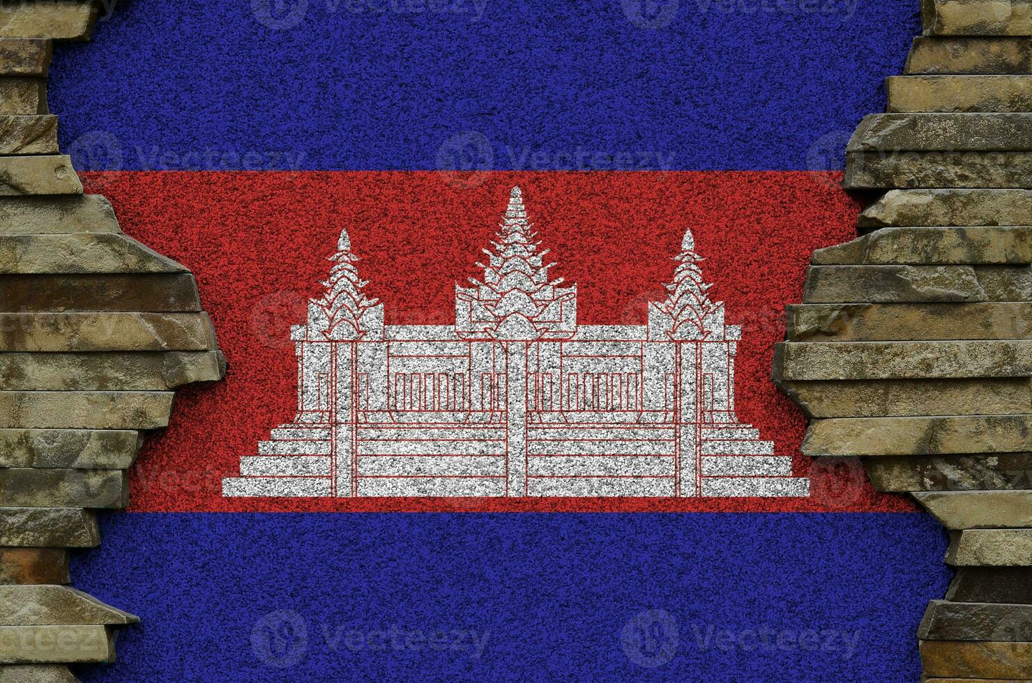 Cambodia flag depicted in paint colors on old stone wall closeup. Textured banner on rock wall background photo