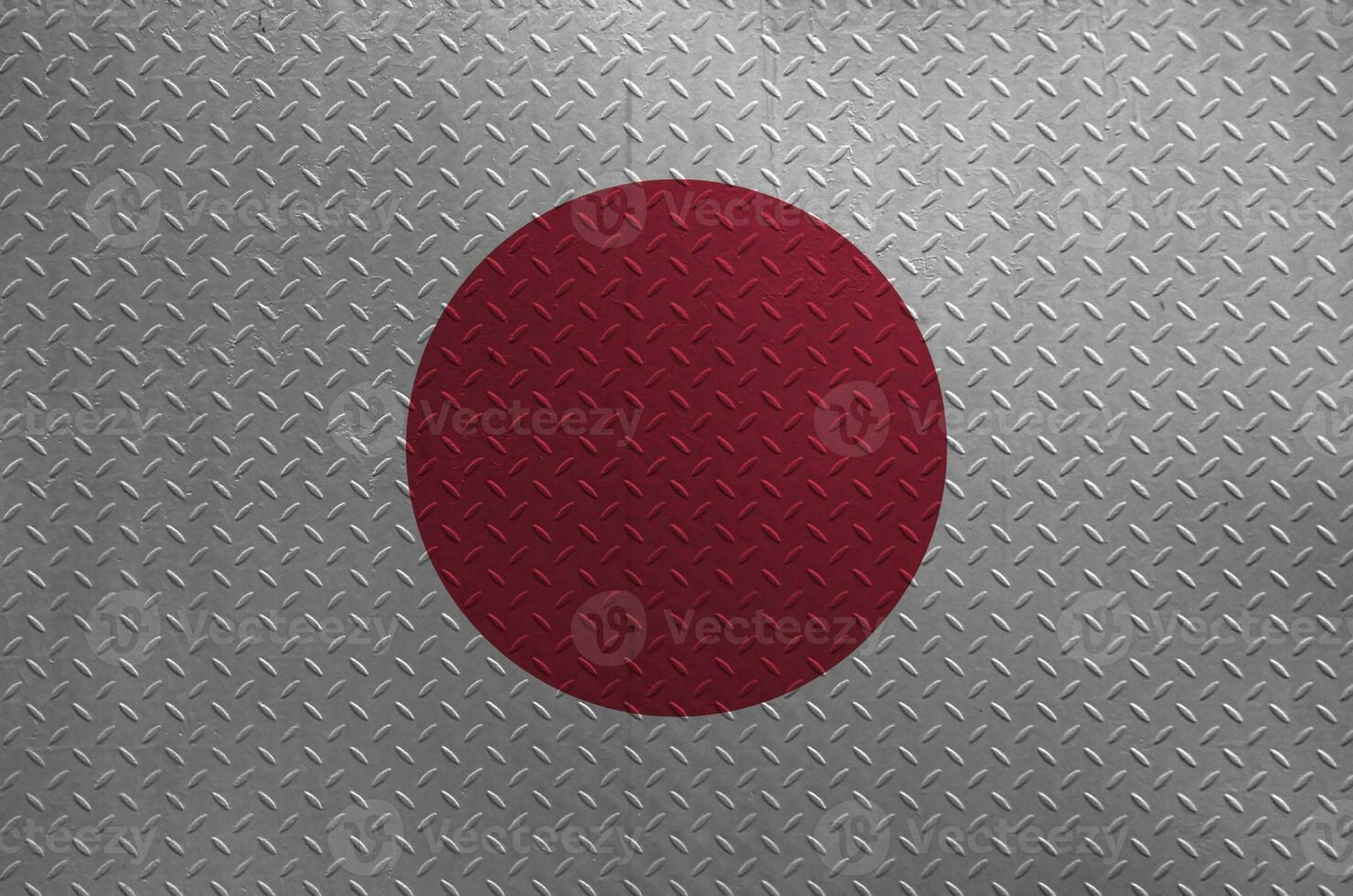 Japan flag depicted in paint colors on old brushed metal plate or wall closeup. Textured banner on rough background photo
