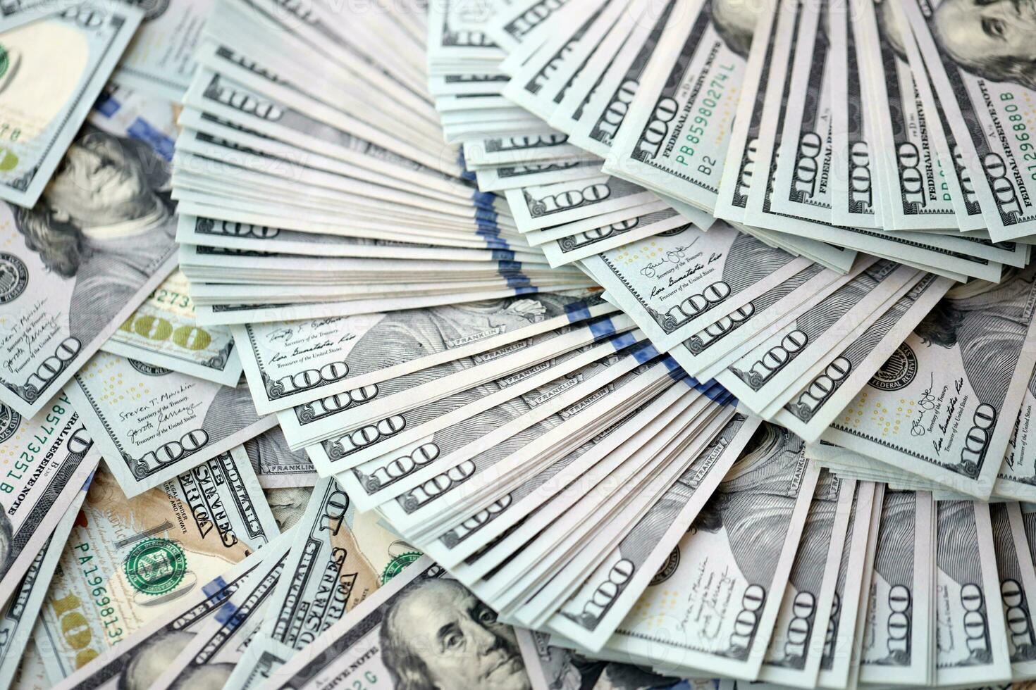 Very big amount of US hundred dollar bills. Huge quantity of united states currency notes on flat table photo