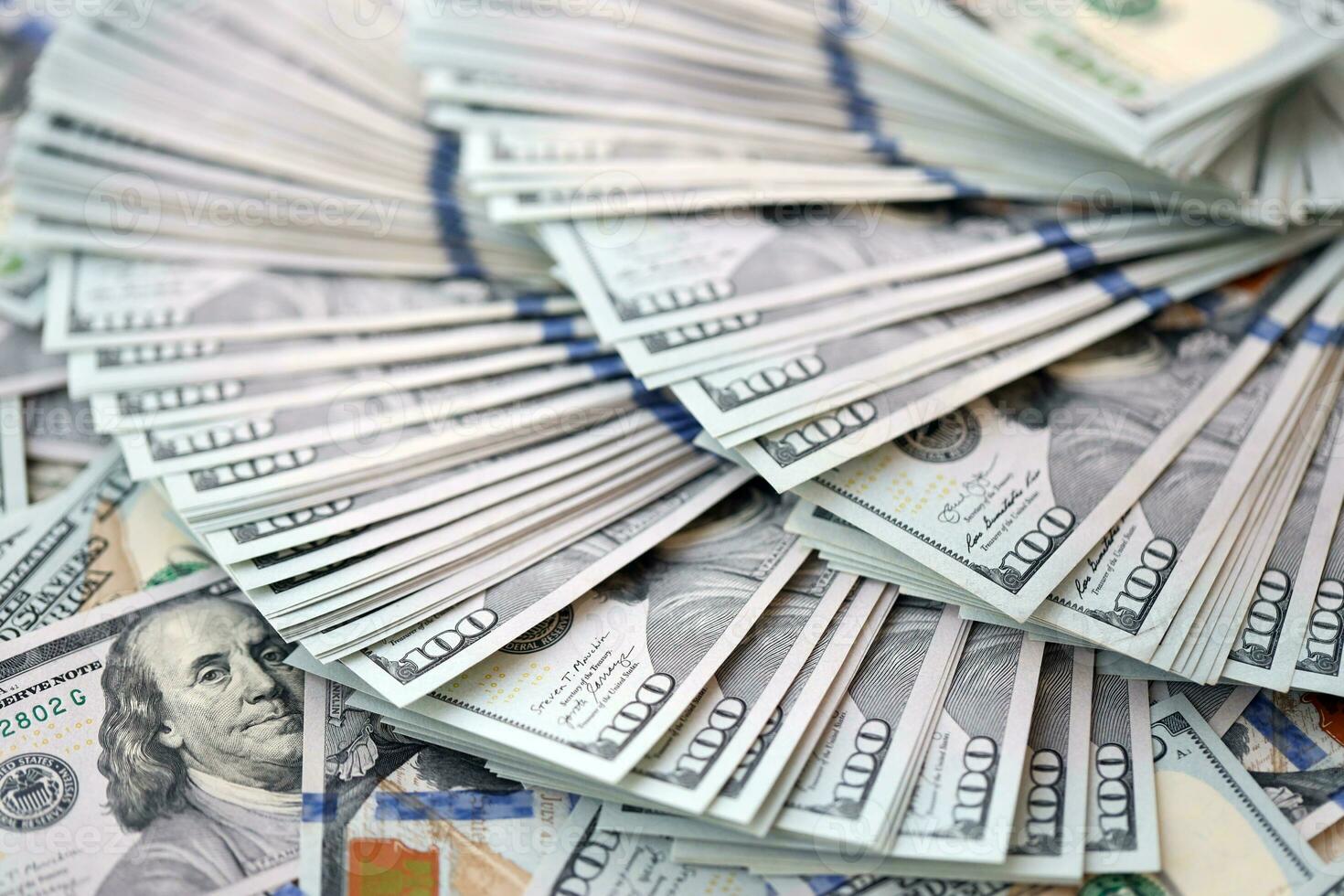 Very big amount of US hundred dollar bills. Huge quantity of united states currency notes on flat table photo