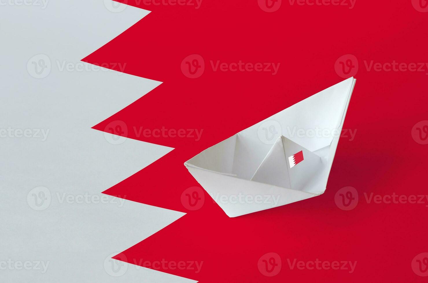 Bahrain flag depicted on paper origami ship closeup. Handmade arts concept photo