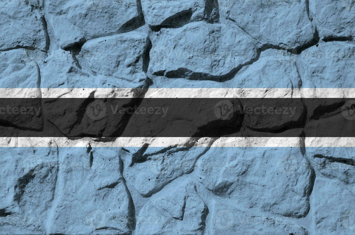 Botswana flag depicted in paint colors on old stone wall closeup. Textured banner on rock wall background photo