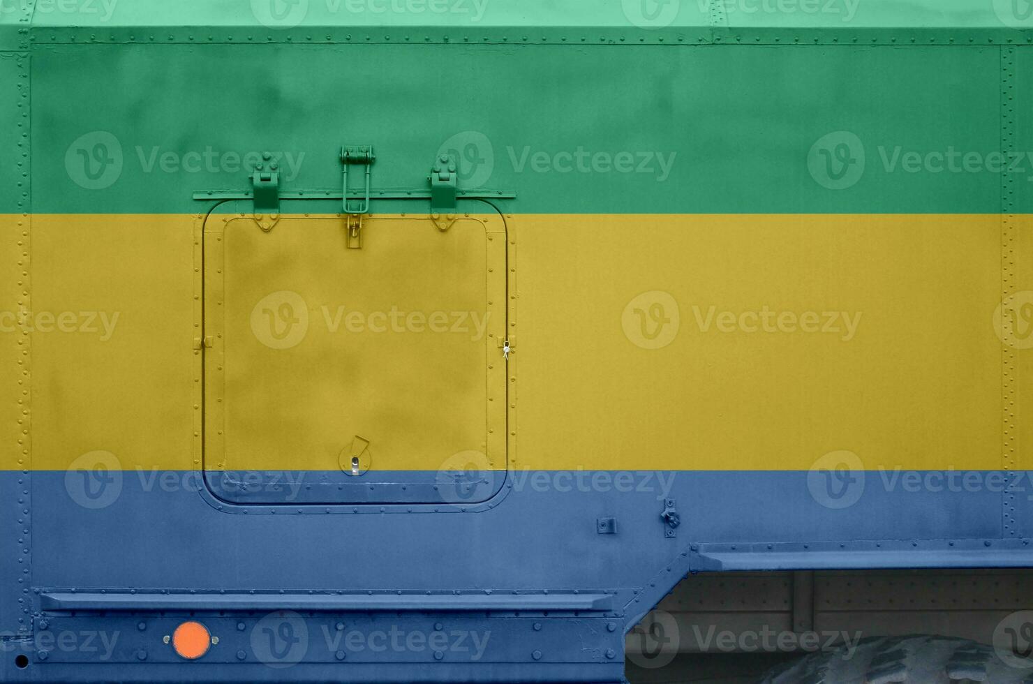 Gabon flag depicted on side part of military armored truck closeup. Army forces conceptual background photo