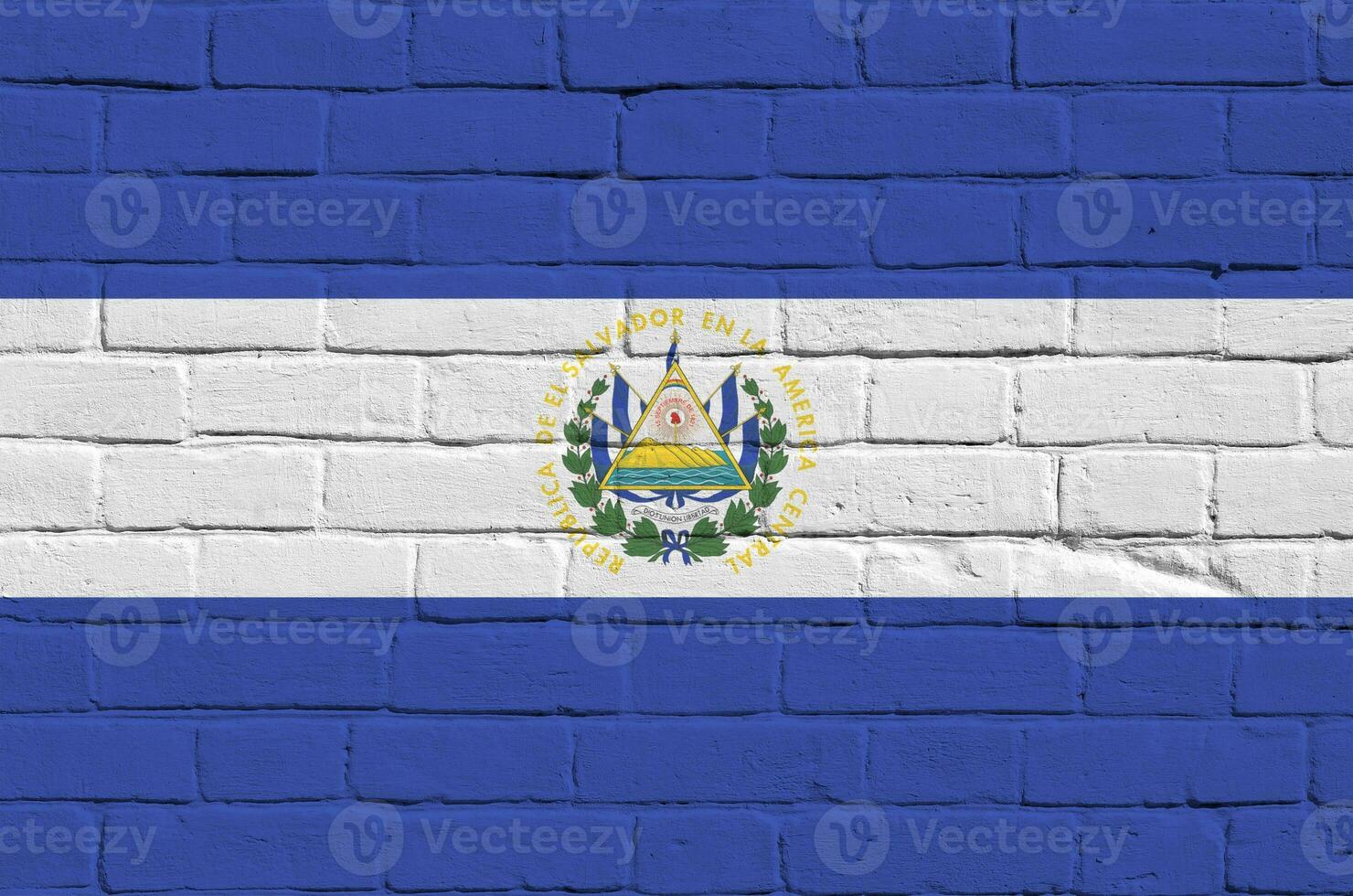 El Salvador flag depicted in paint colors on old brick wall. Textured banner on big brick wall masonry background photo