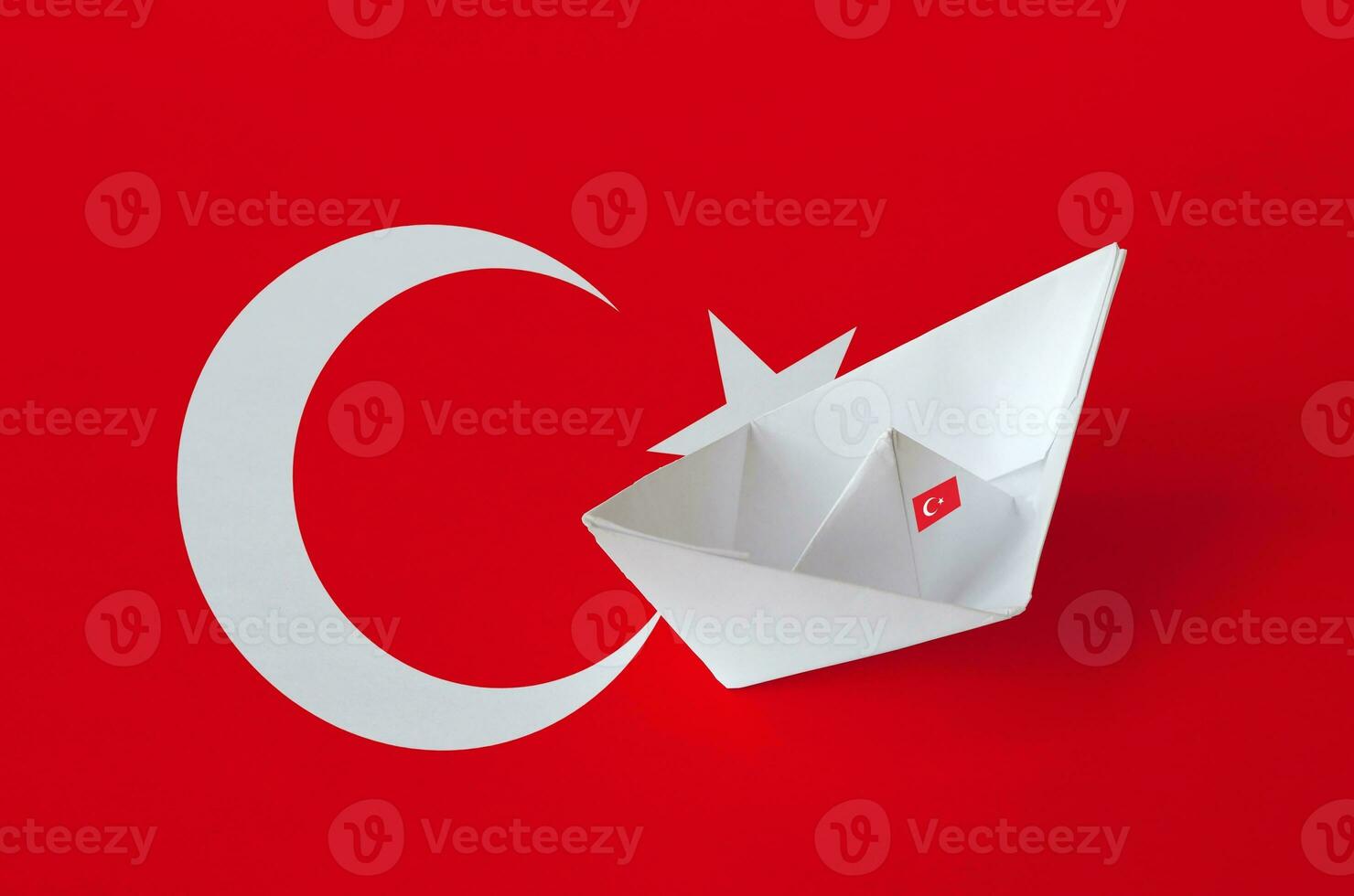 Turkey flag depicted on paper origami ship closeup. Handmade arts concept photo