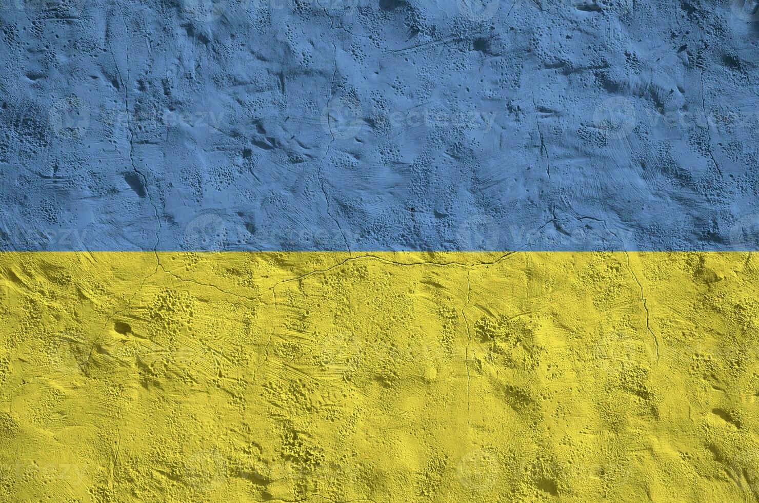 Ukraine flag depicted in bright paint colors on old relief plastering wall. Textured banner on rough background photo