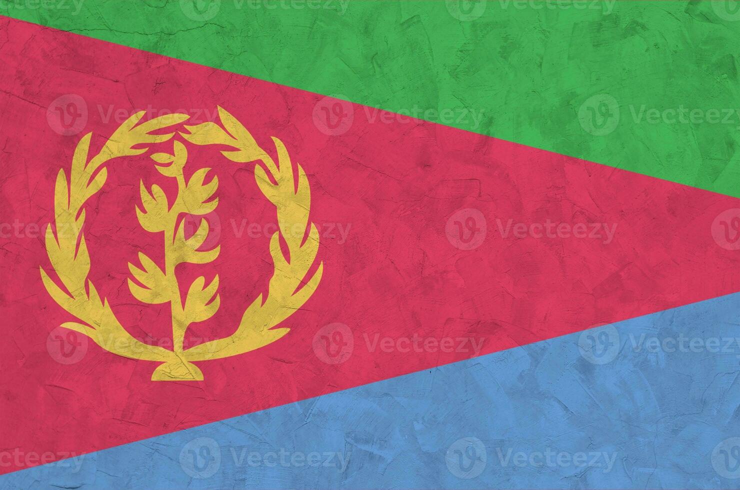 Eritrea flag depicted in bright paint colors on old relief plastering wall. Textured banner on rough background photo