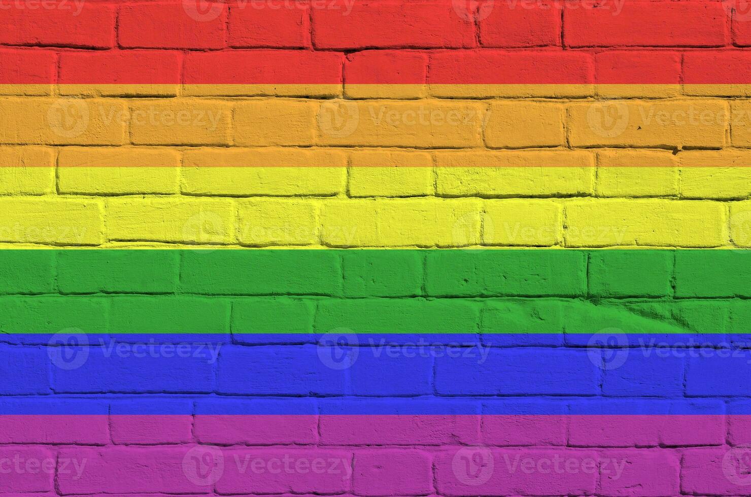 LGBT community flag depicted in paint colors on old brick wall. Textured banner on big brick wall masonry background photo