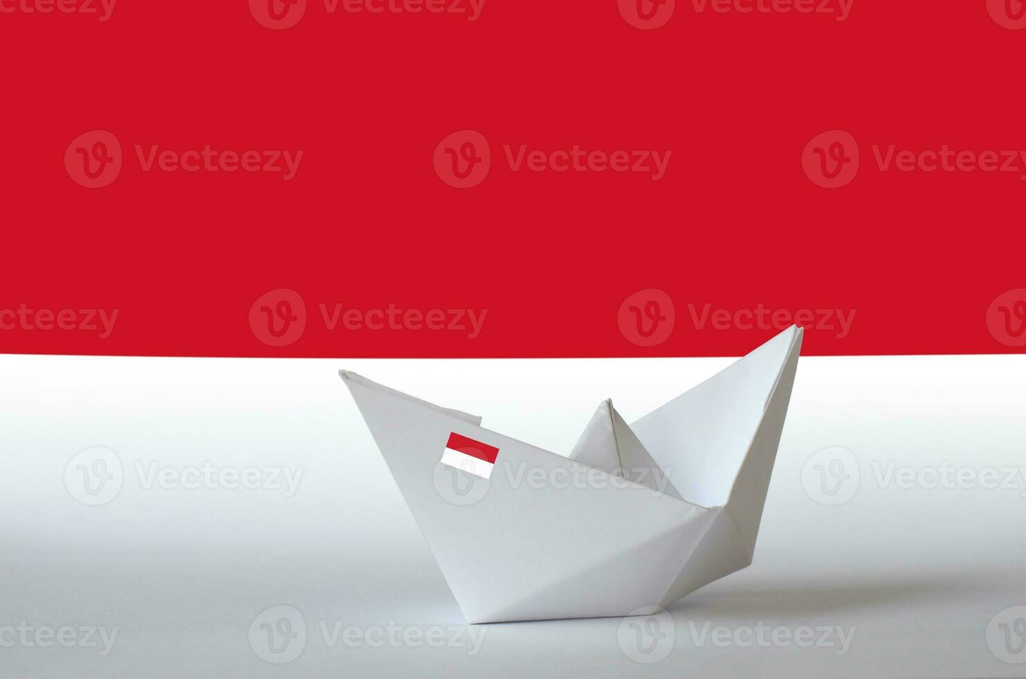 Monaco flag depicted on paper origami ship closeup. Handmade arts concept photo