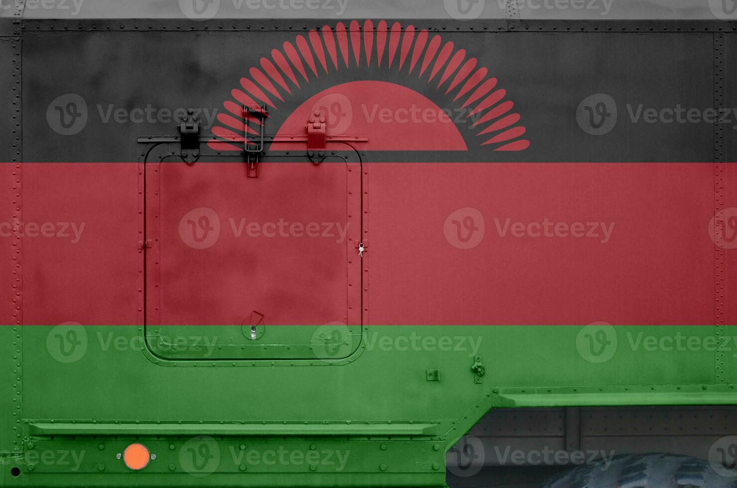 Malawi flag depicted on side part of military armored truck closeup. Army forces conceptual background photo