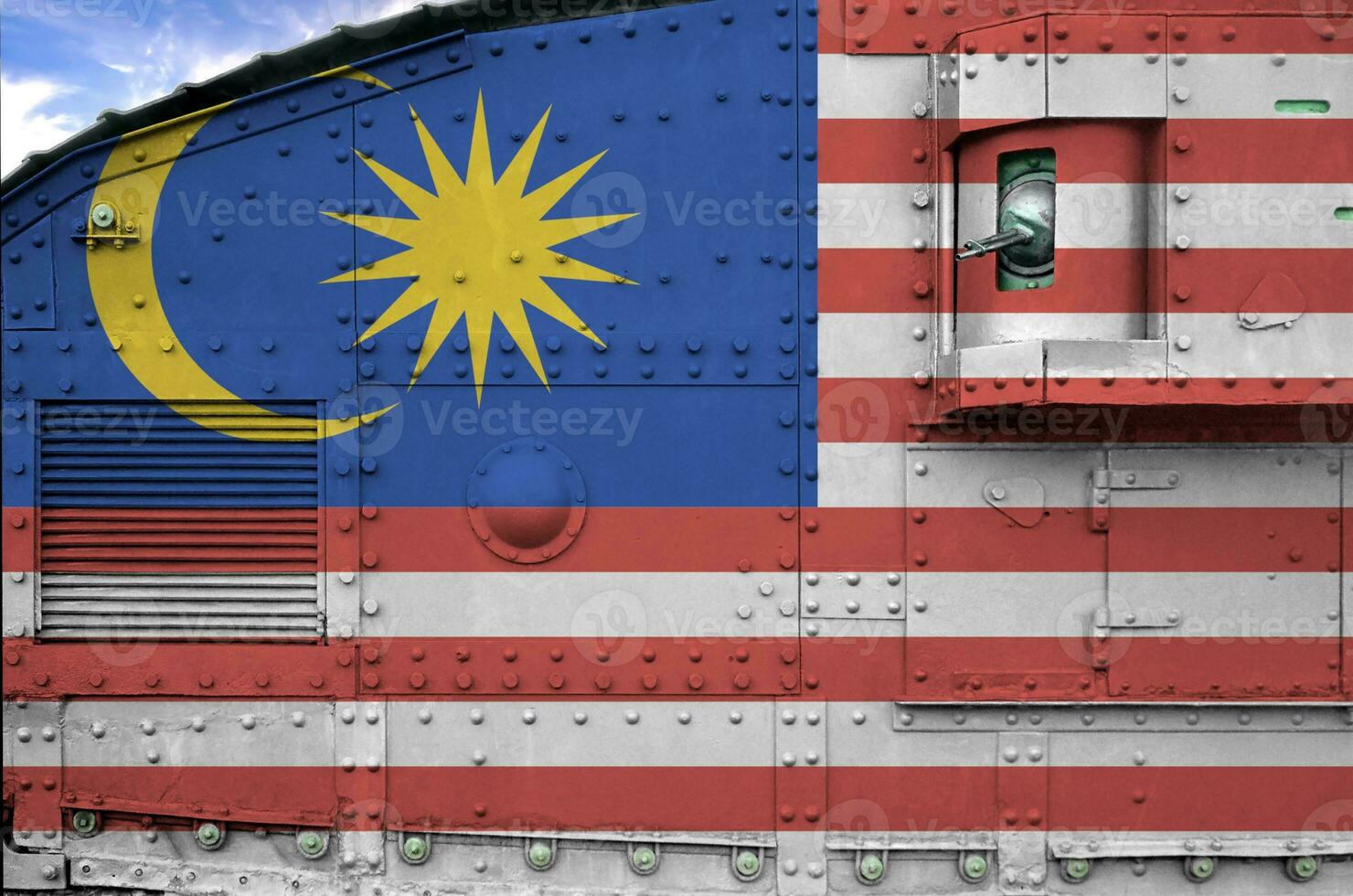 Malaysia flag depicted on side part of military armored tank closeup. Army forces conceptual background photo