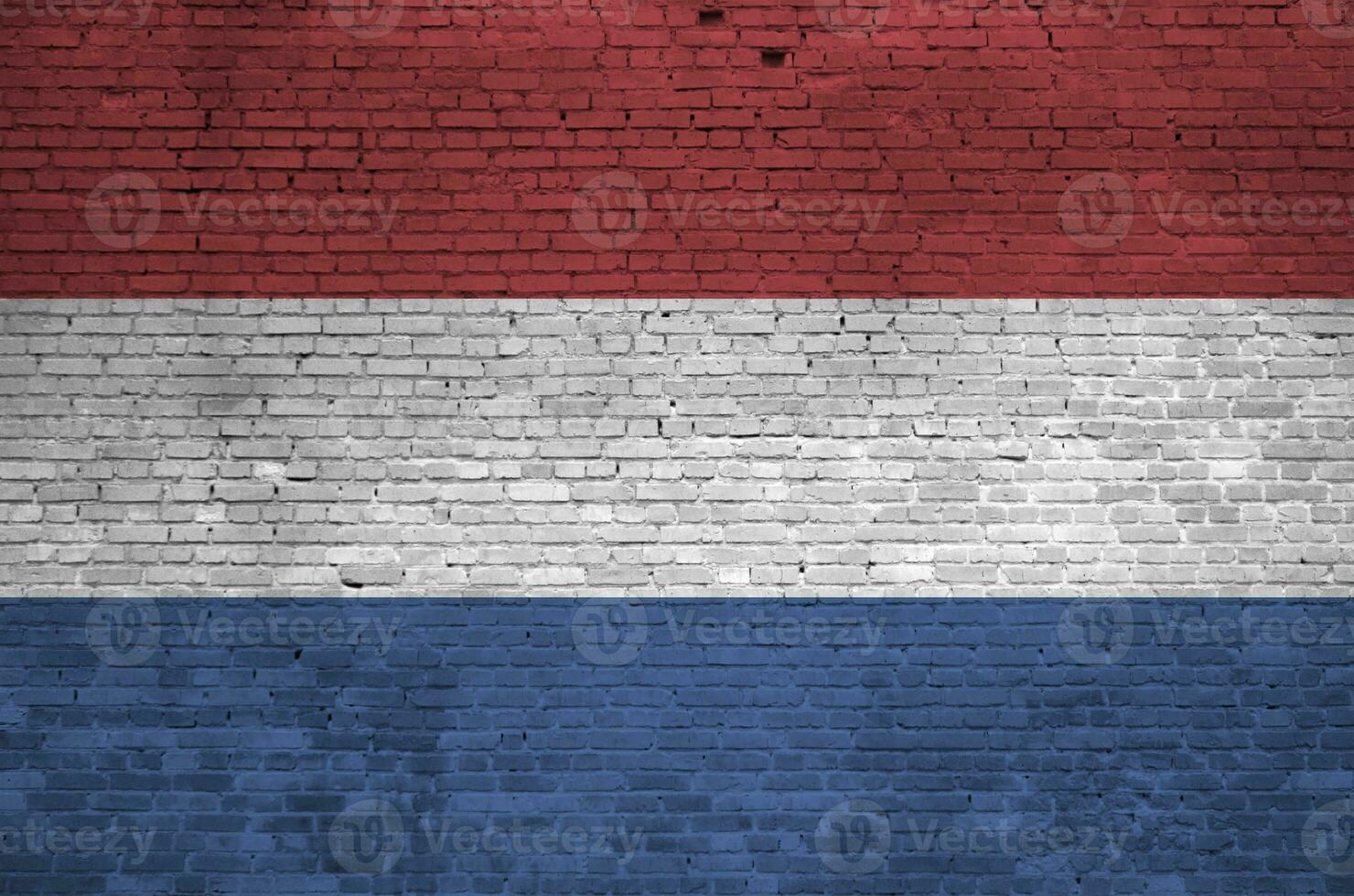 Netherlands flag depicted in paint colors on old brick wall. Textured banner on big brick wall masonry background photo