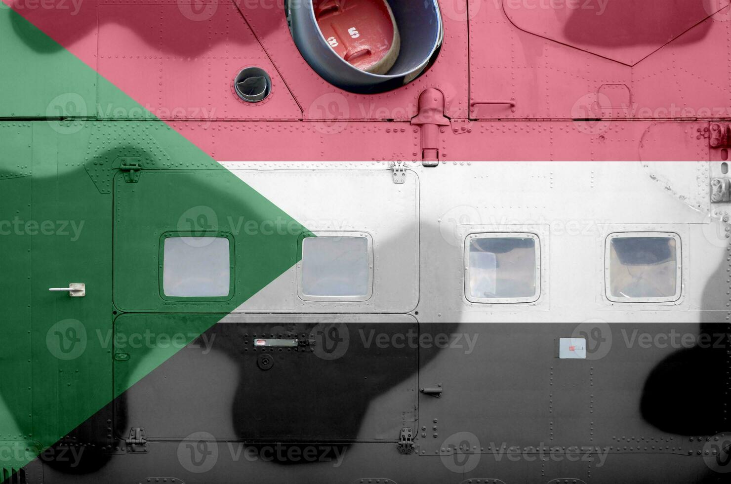 Sudan flag depicted on side part of military armored helicopter closeup. Army forces aircraft conceptual background photo