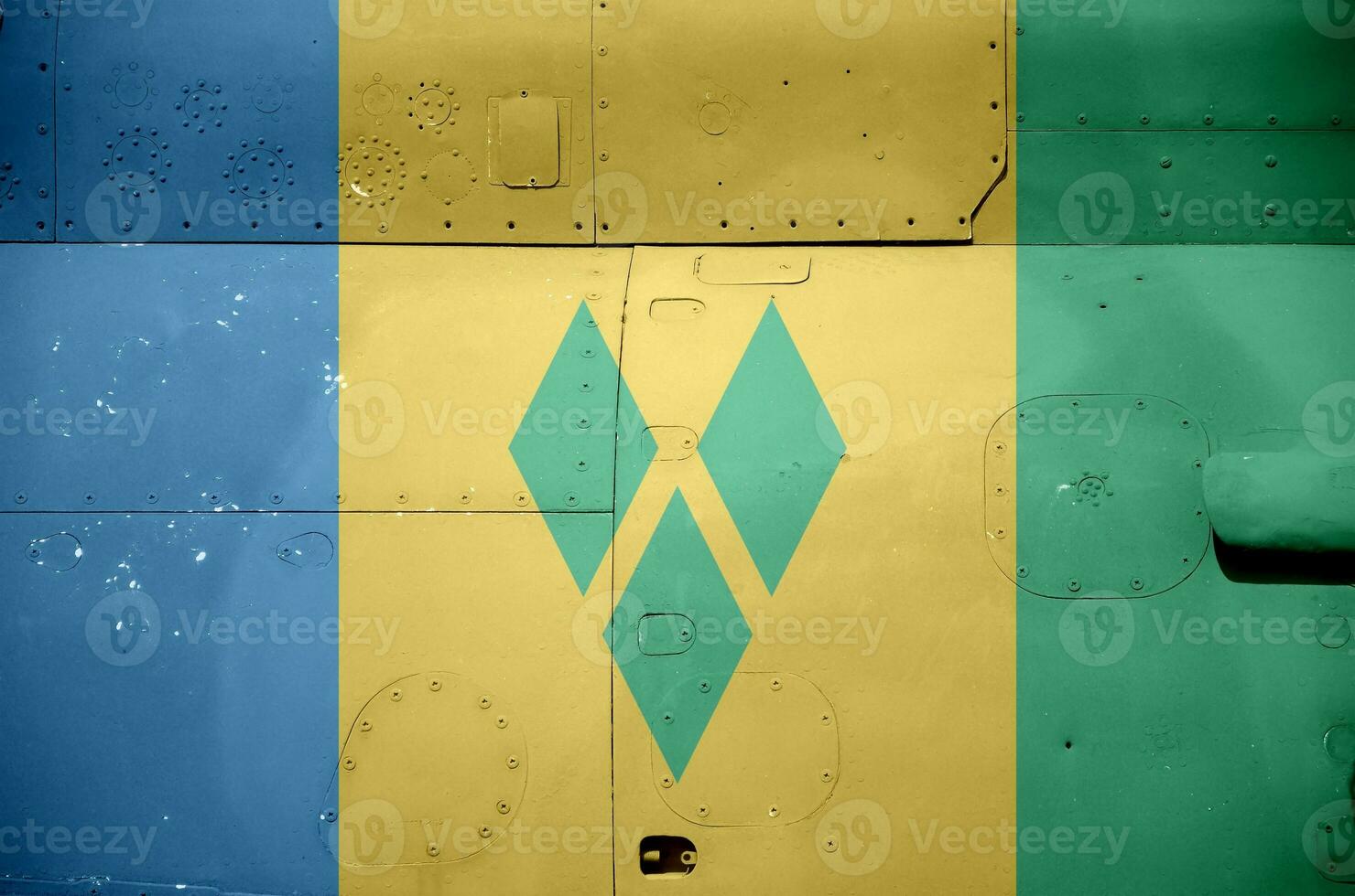 Saint Vincent and the Grenadines flag depicted on side part of military armored helicopter closeup. Army forces aircraft conceptual background photo