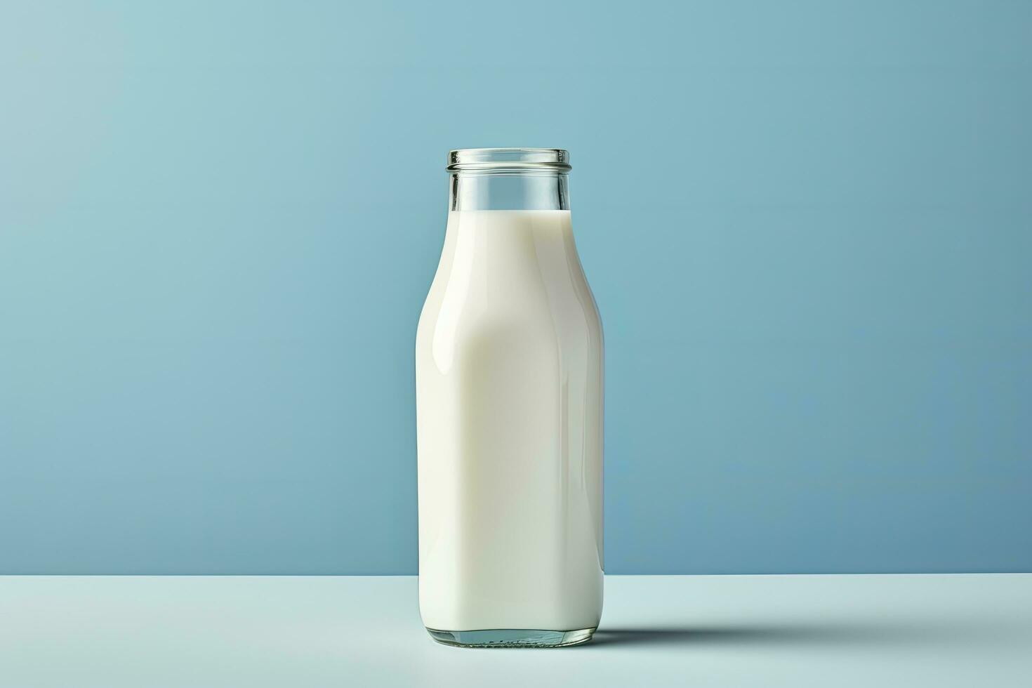 AI generated A glass bottle with full milk on blue background. AI Generated photo