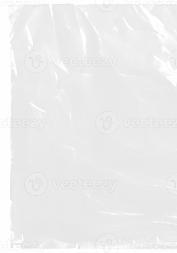 plastic cellophane bag on white background. The texture looks blank and shiny. The plastic surface is wrinkly and tattered making abstract pattern. photo