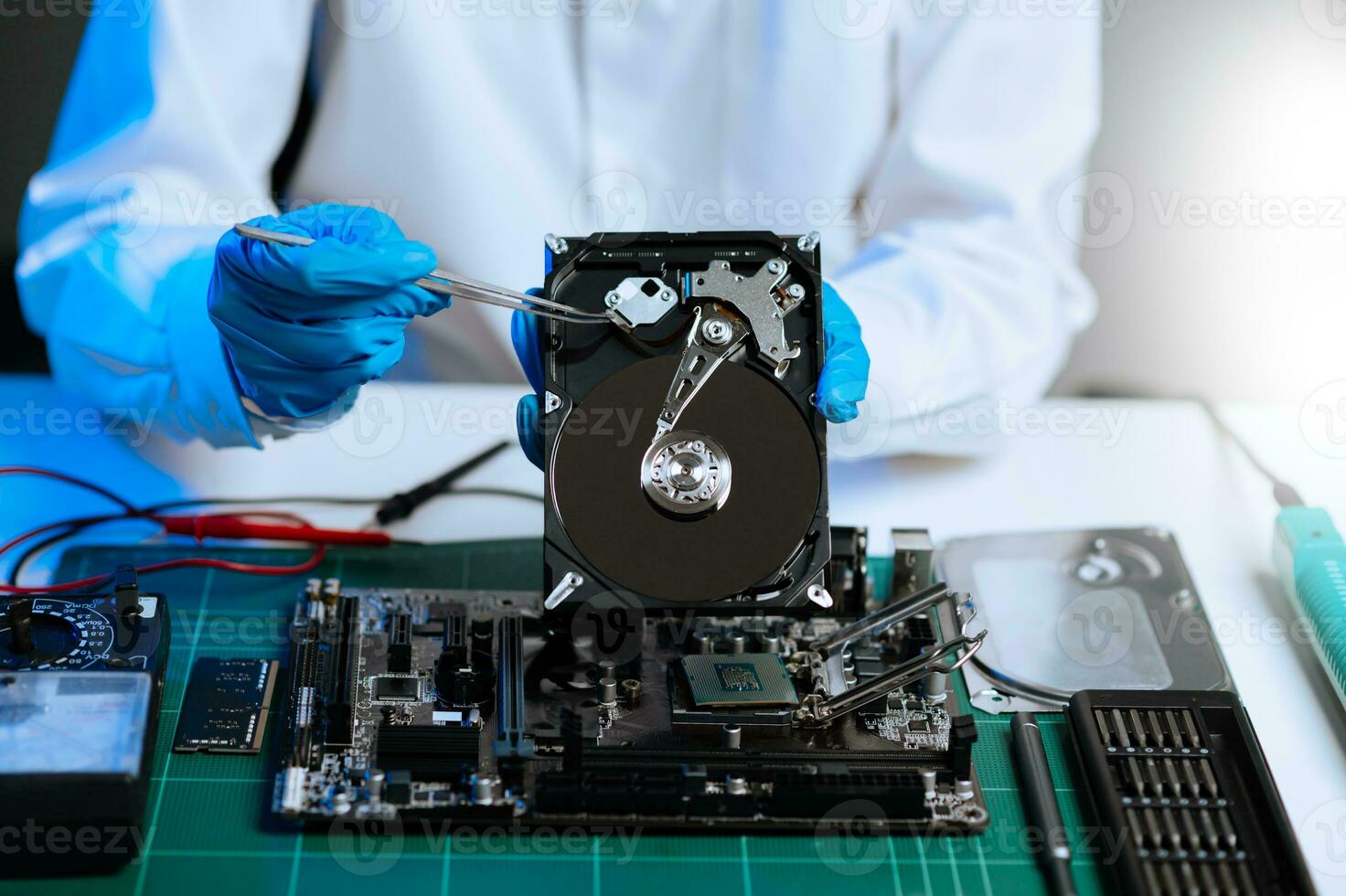 Electronics technician, electronic engineering electronic repair, electronics measuring and testing, repair and maintenance concepts.uses a voltage meter to check and upgrade in shop photo
