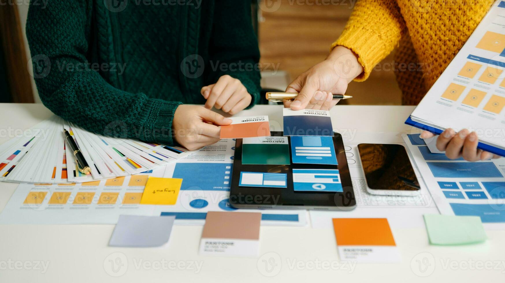 UX developer and ui designer brainstorming about mobile app interface wireframe design with customer breif and color code photo