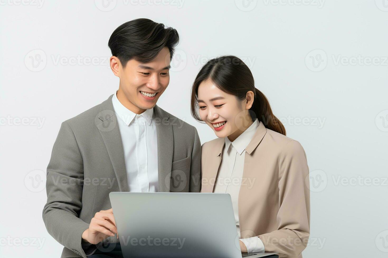 AI generated happy young Asian co worker holding and looking at laptop on white isolated background photo
