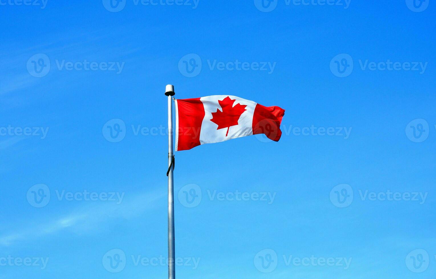 The flag of Canada on blue sky  background close up. photo