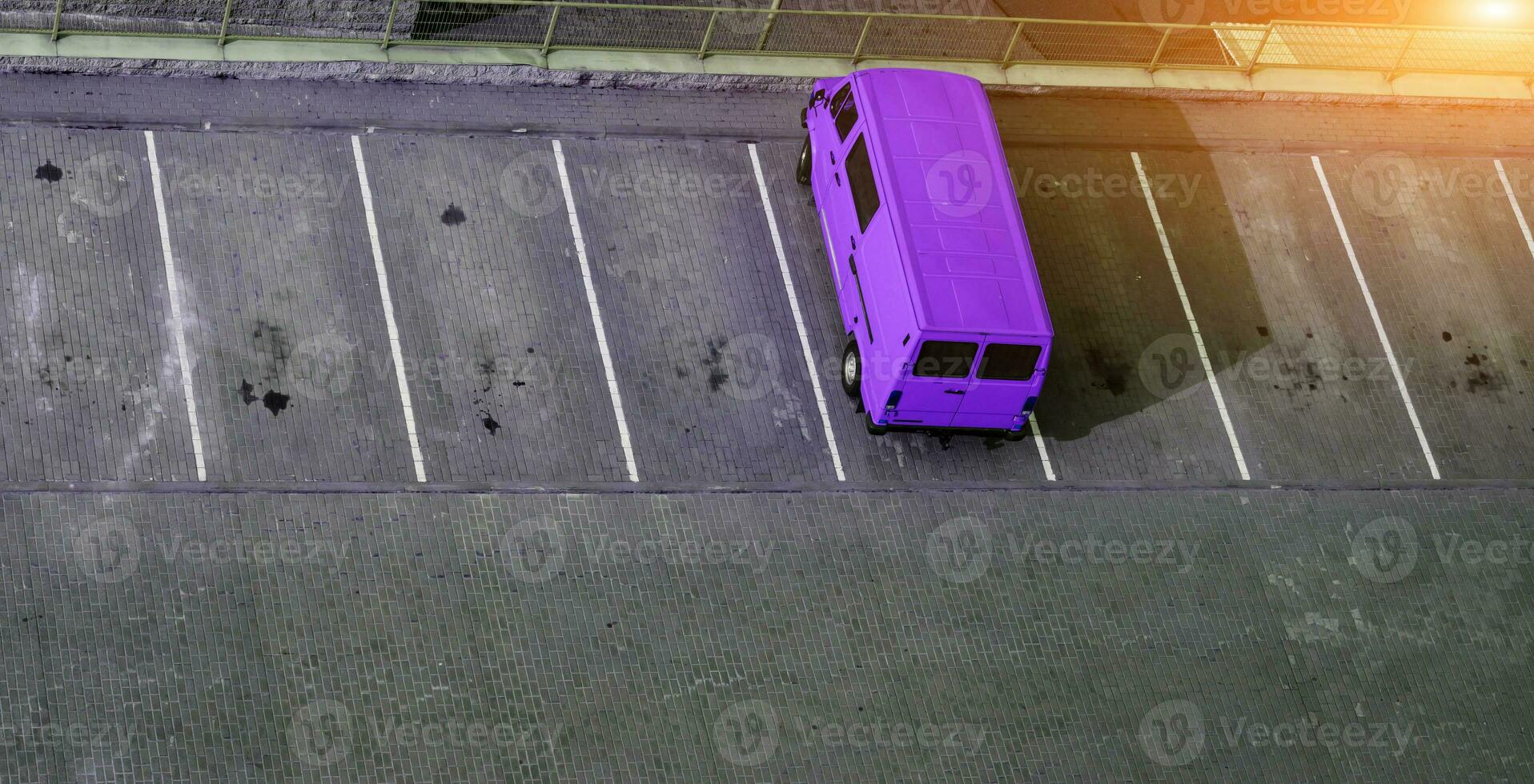 blue van is standing in parking photo