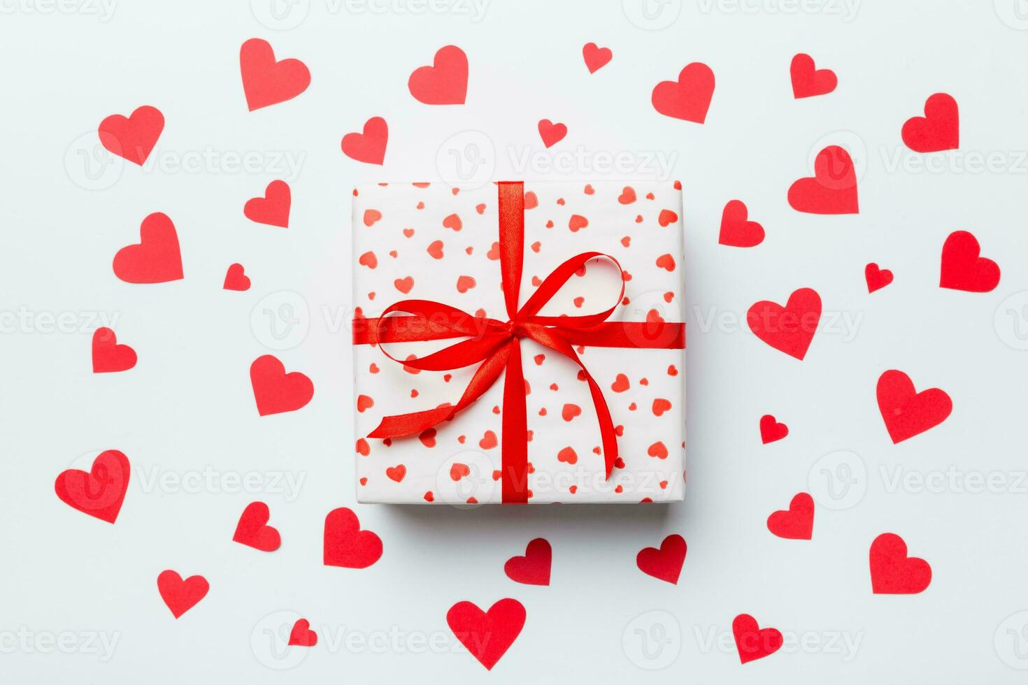 Valentine day composition red  gift box with bow and heart. Christmas present. View from above. Holday greeting card photo