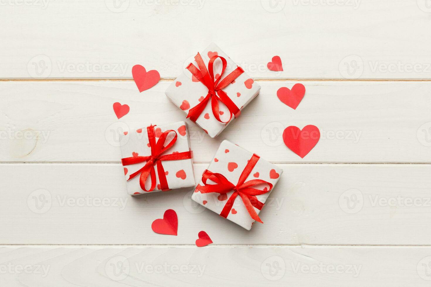 Valentine day composition red  gift box with bow and heart. Christmas present. View from above. Holday greeting card photo