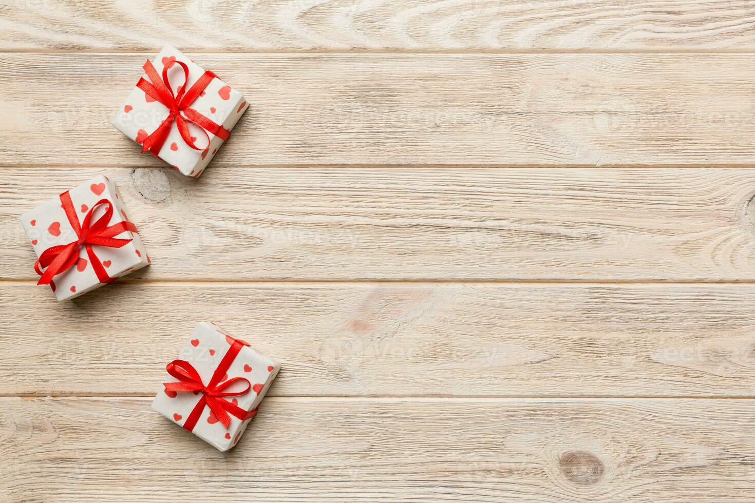Valentine day composition red  gift box with bow and heart. Christmas present. View from above. Space for text. Holday greeting card photo