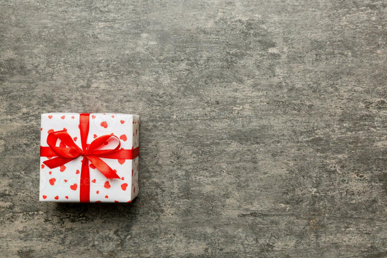 Valentine day composition red  gift box with bow and heart. Christmas present. View from above. Space for text. Holday greeting card photo