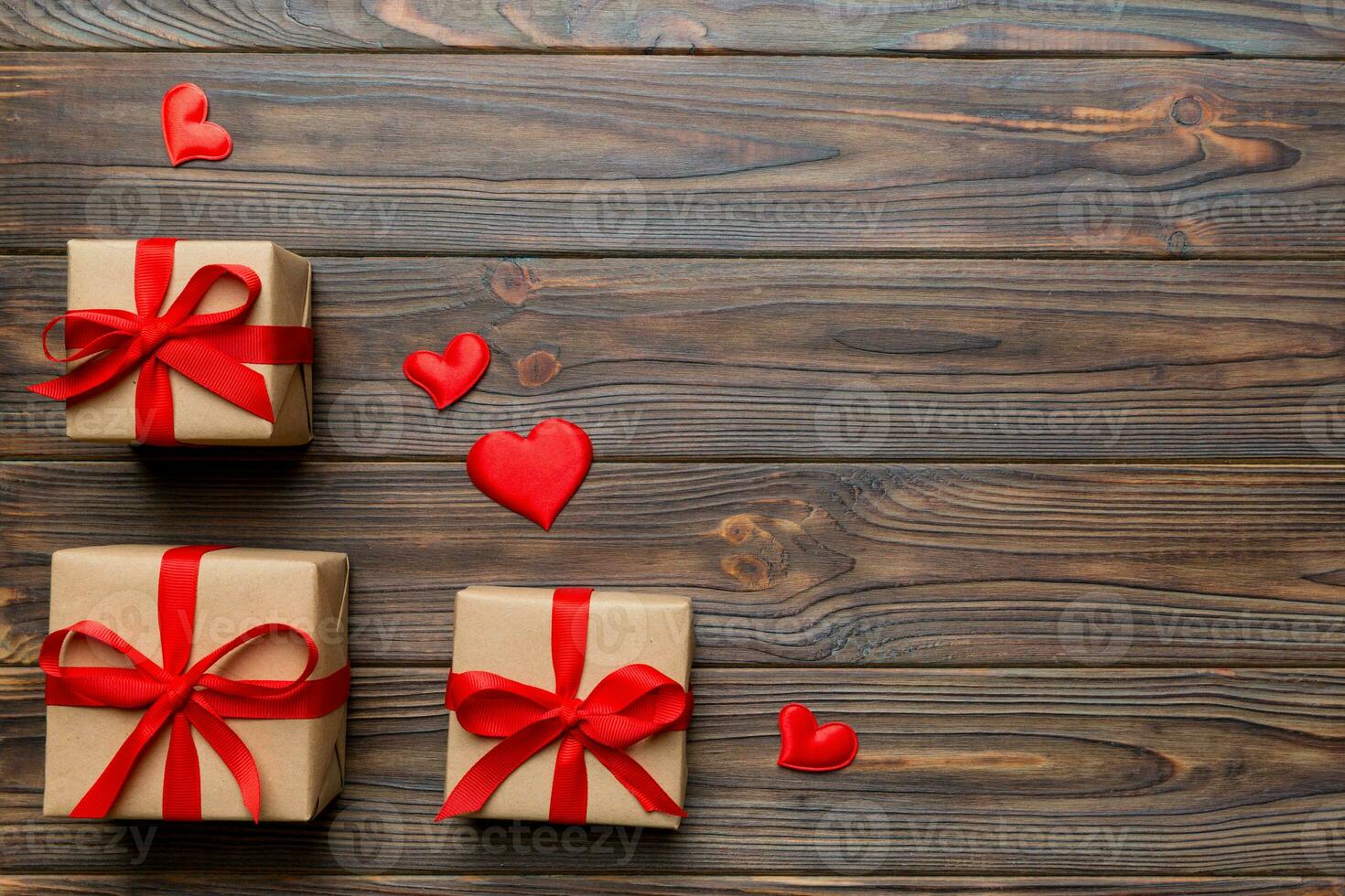Valentine day composition red  gift box with bow and heart. Christmas present. View from above. Space for text. Holday greeting card photo