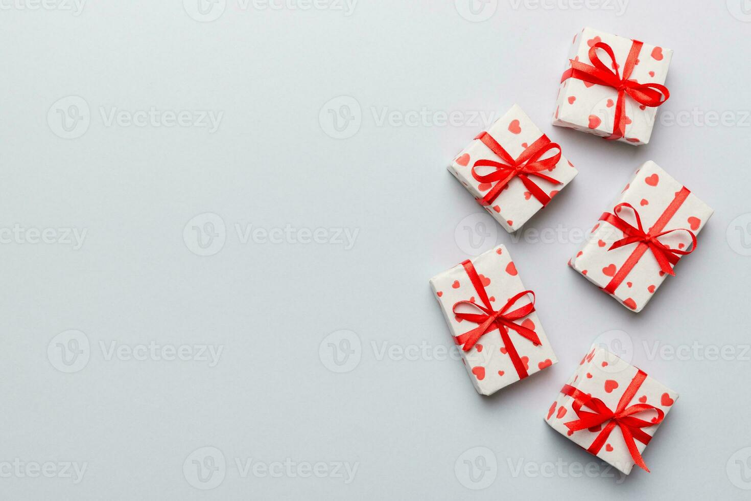 Valentine day composition red  gift box with bow and heart. Christmas present. View from above. Space for text. Holday greeting card photo