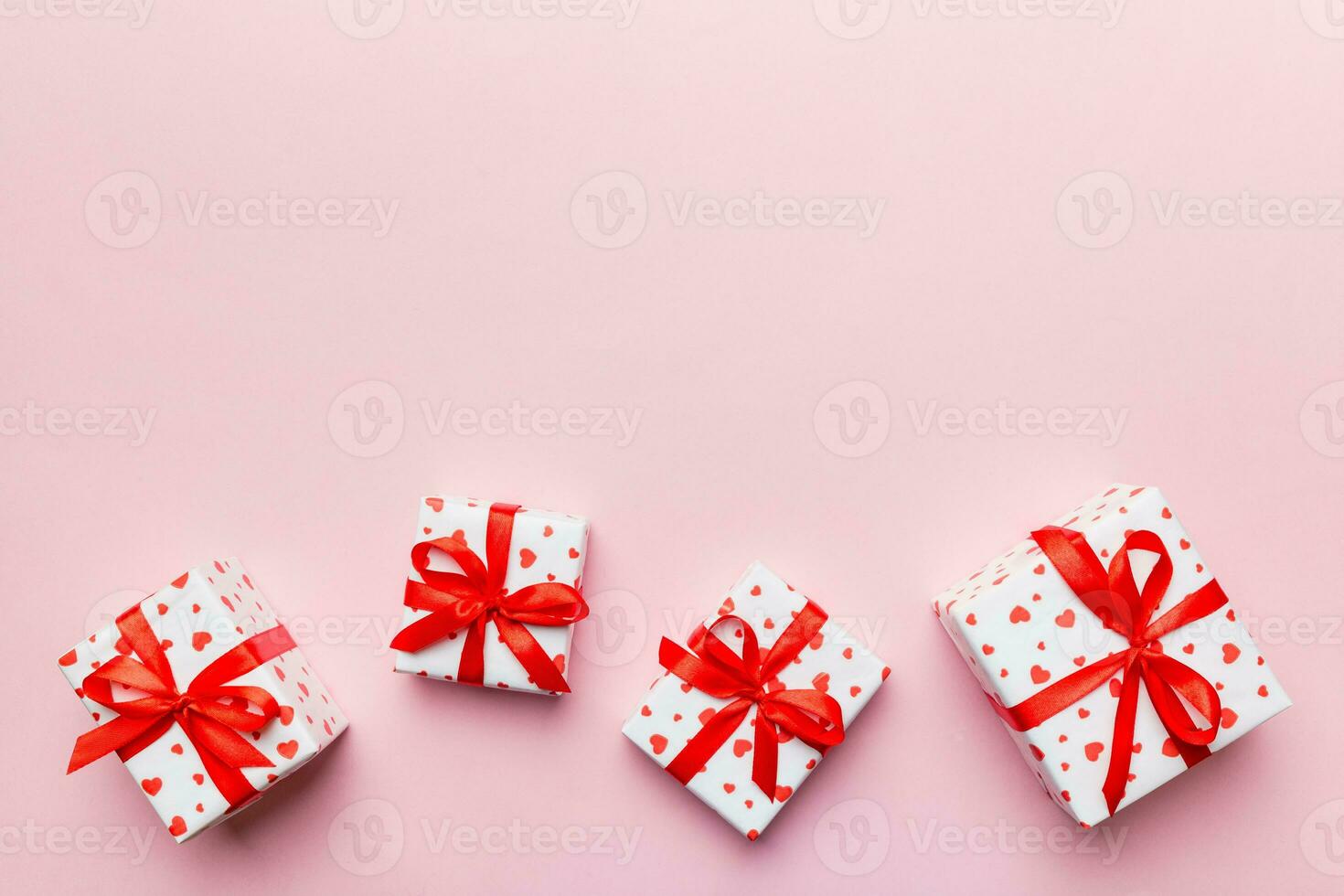 Valentine day composition red  gift box with bow and heart. Christmas present. View from above. Space for text. Holday greeting card photo