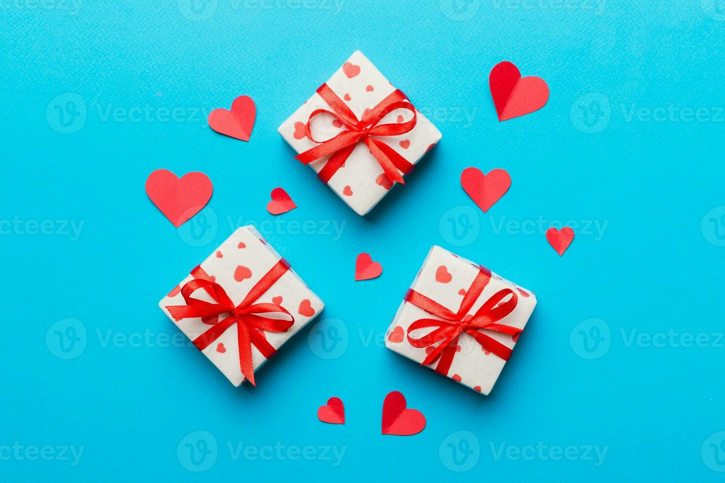 Valentine day composition red  gift box with bow and heart. Christmas present. View from above. Holday greeting card photo