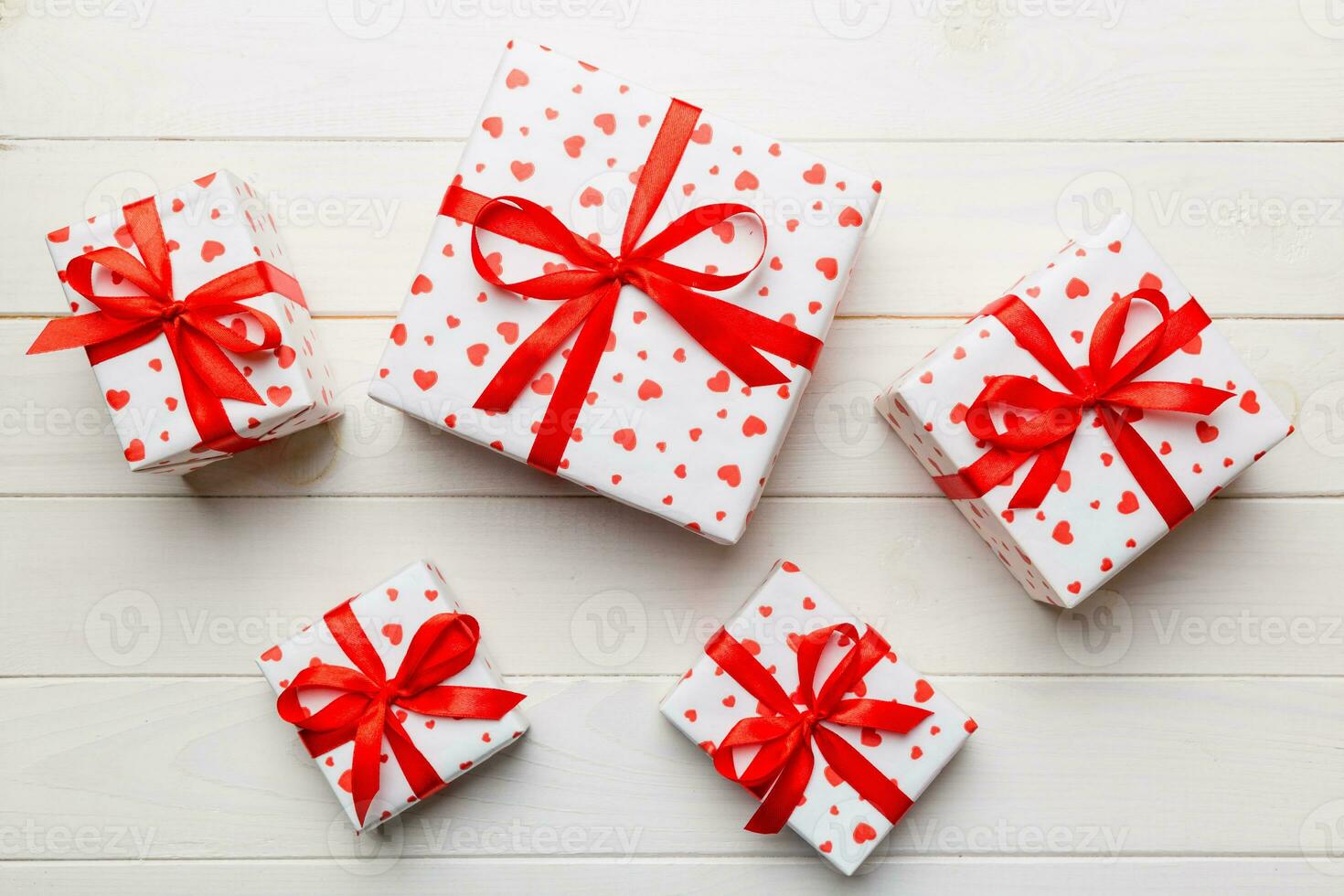 Valentine day composition red  gift box with bow and heart. Christmas present. View from above. Holday greeting card photo
