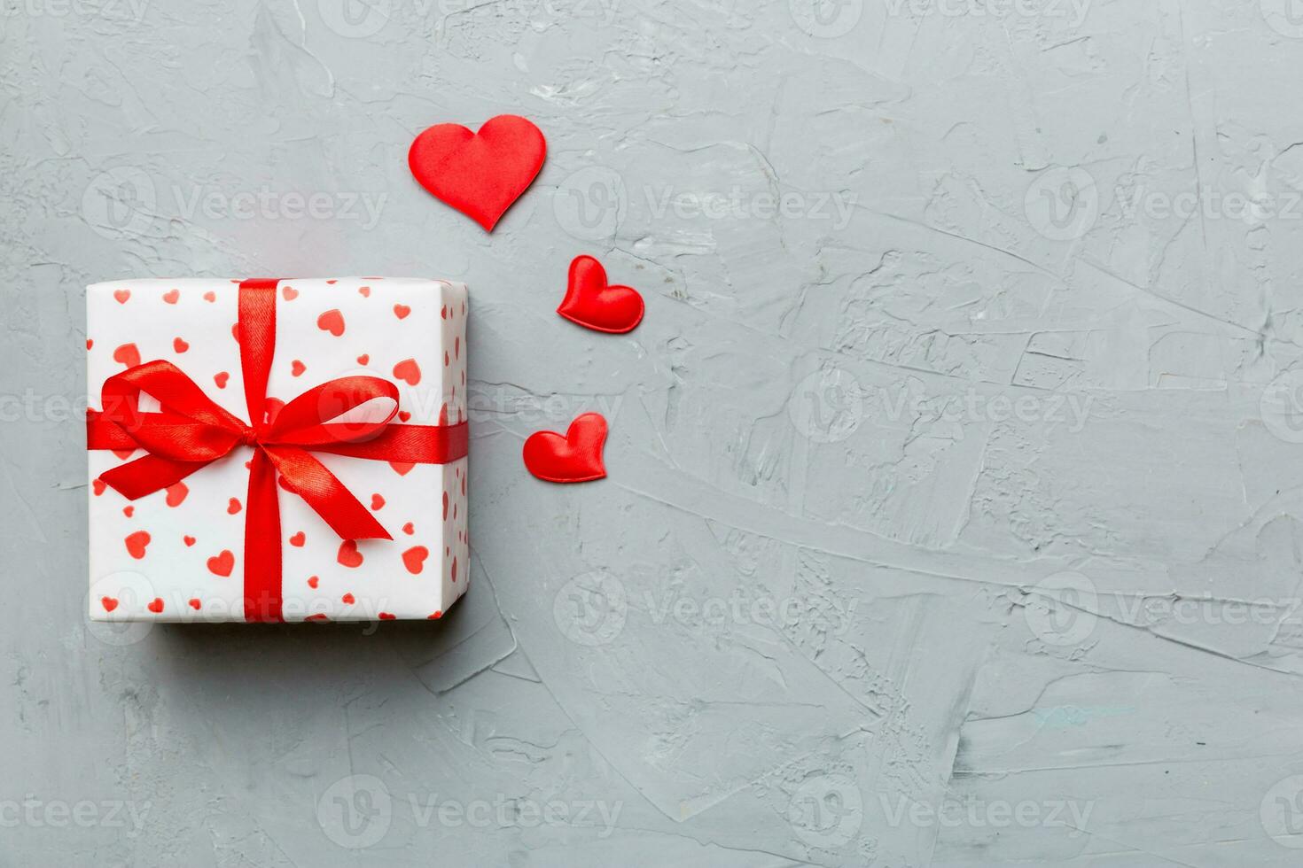 Valentine day composition red  gift box with bow and heart. Christmas present. View from above. Space for text. Holday greeting card photo