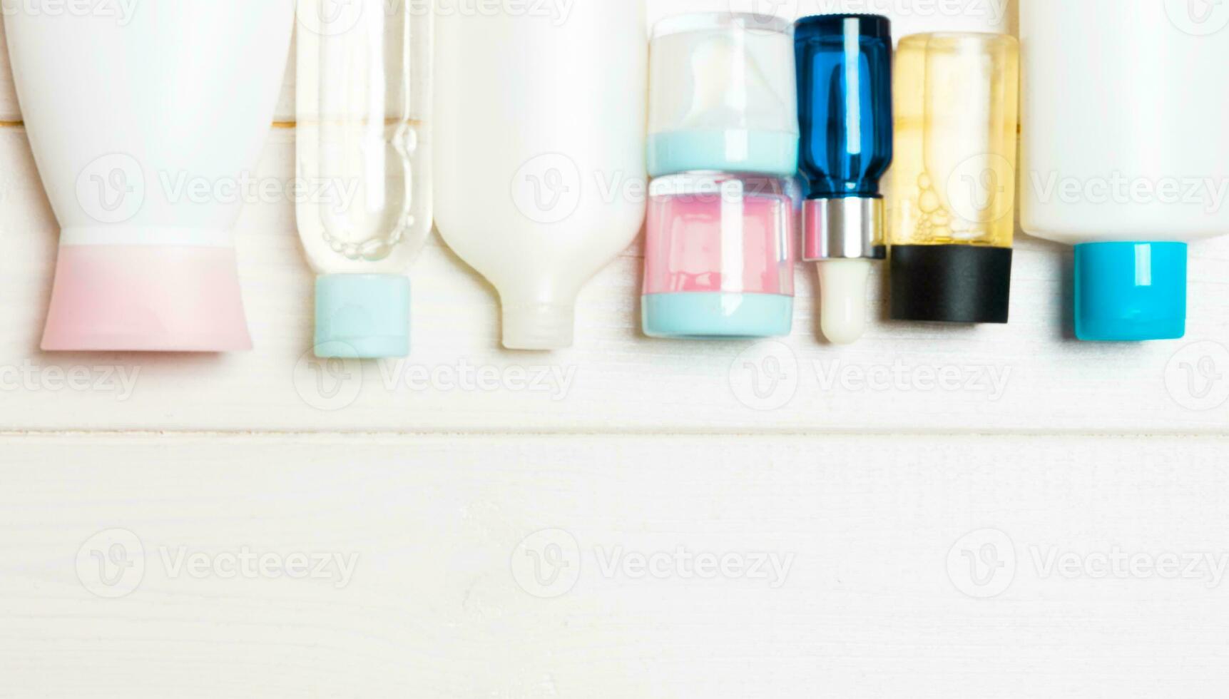Flat lay composition with cosmetic and cream bottles on wooden background. Beauty products concept with copy space photo
