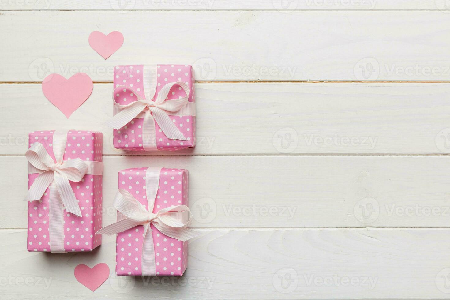 Valentine day composition red gift box with bow and heart. Christmas present. View from above. Space for text. Holday greeting card photo